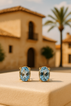 •	Gold-Plated Sterling Silver Aquamarine Stud Earrings on Cream Satin