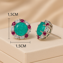 Front view of 1.5 cm round tourmaline surrounded by white quartz and rubies