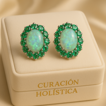 “Close-up of natural opal earrings surrounded by vivid green emeralds