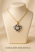 Close-up of white quartz gemstone in artisanal enamel heart necklace.