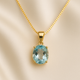 Oval aquamarine pendant necklace in gold-plated sterling silver on cream jewelry box